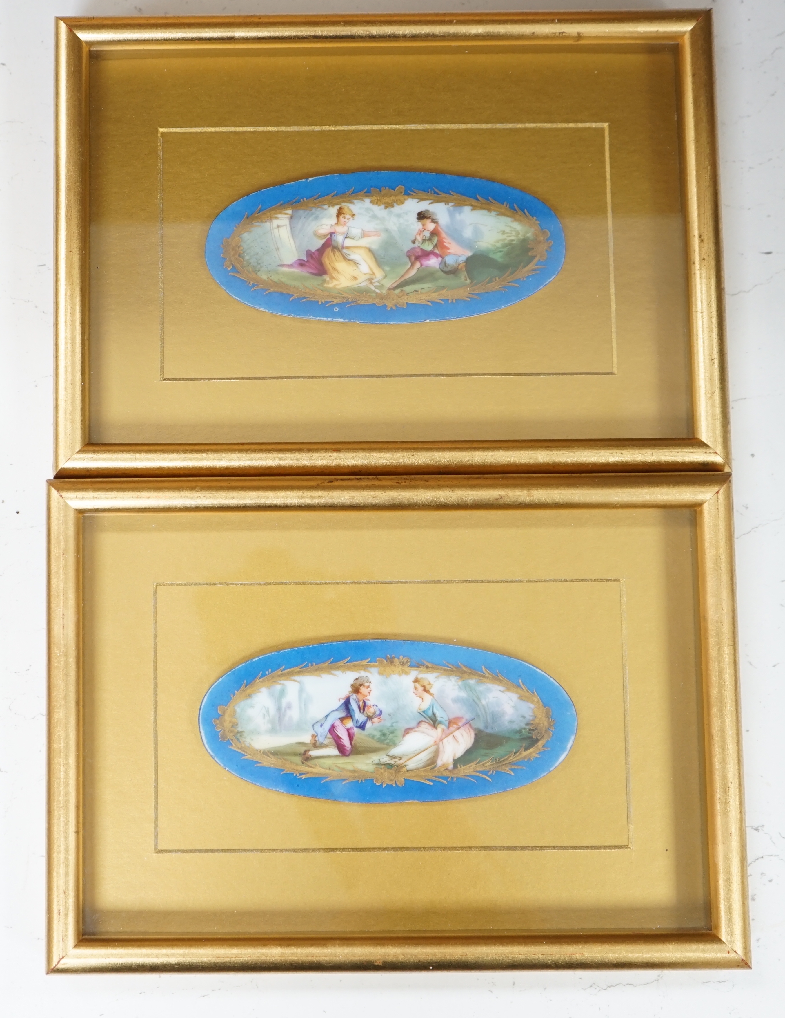 A pair of framed Sevres style porcelain oval plaques and a papier mache panel, inscribed verso and dated 1797, pair 26cm x 18cm